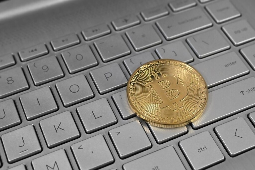 Bitcoin coins on a laptop keyboard representing cryptocurrency tax