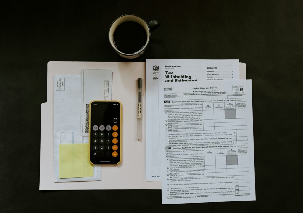 Tax withholding form with calculator and pen