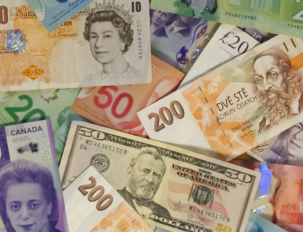A collection of international banknotes including US dollars