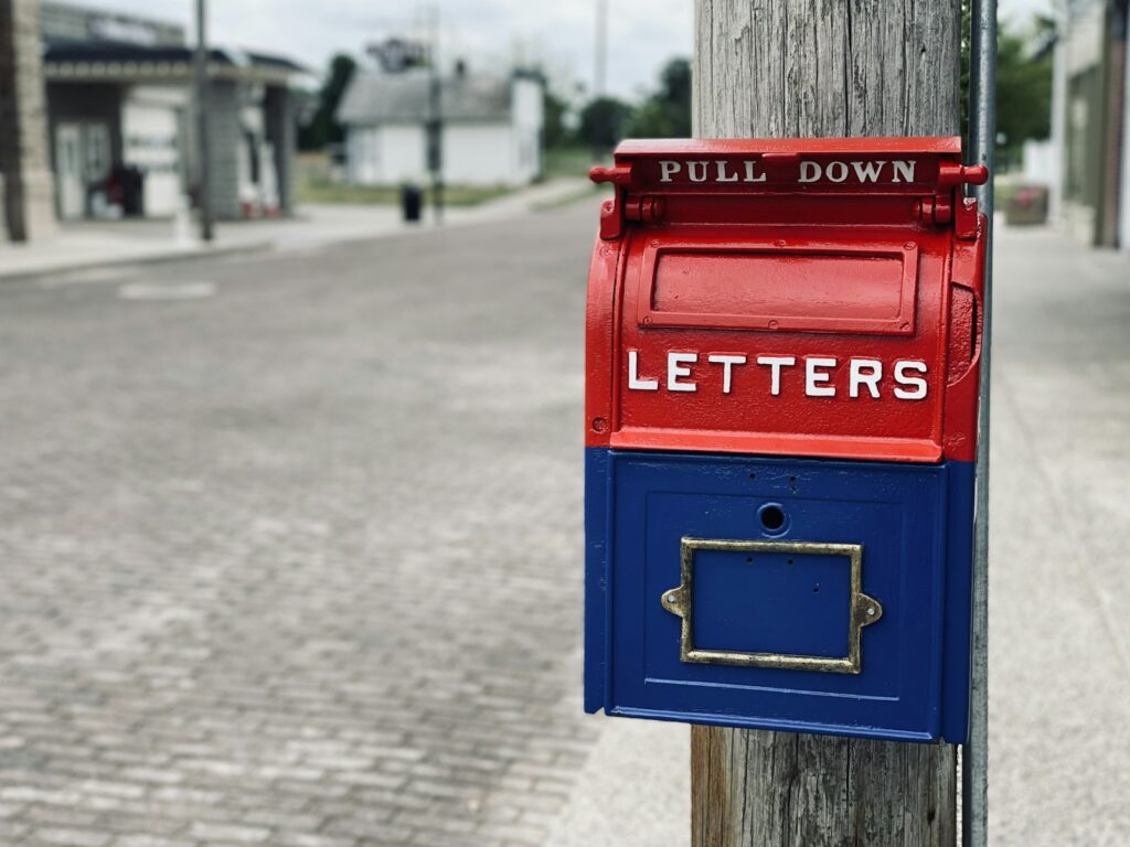 What Is a Registered Agent? Role, Cost, How to Change One, and the Risks of Letting It Lapse red mail box on brown wooden post
