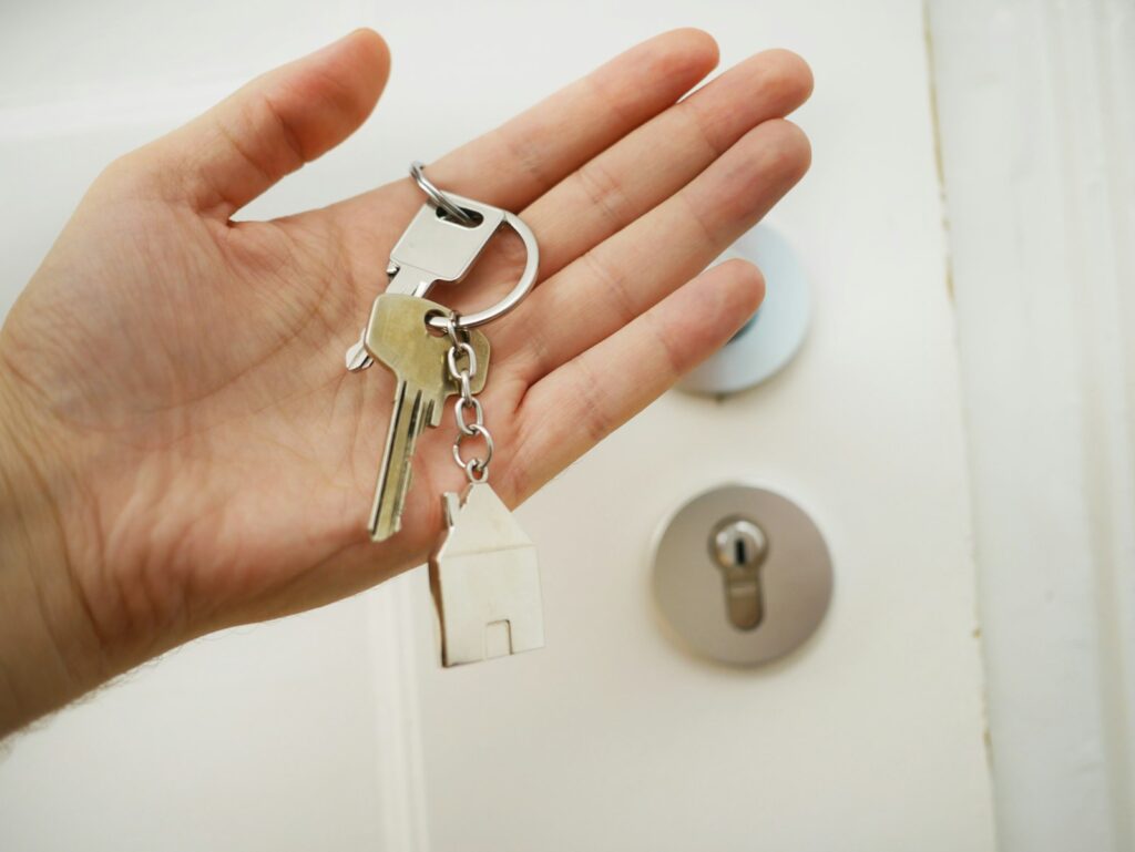 Keys held in a hand at a door
