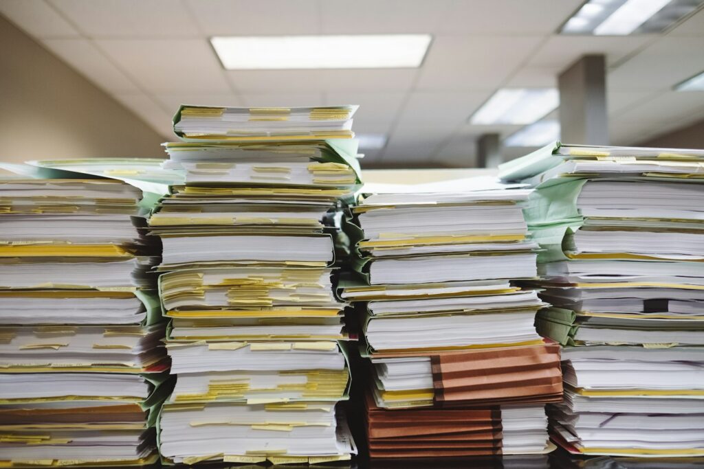 Received a Schedule K-1? How to Report Partnership and Real Estate Fund Investments, and the State Tax Traps stacks of paper documents and file folders