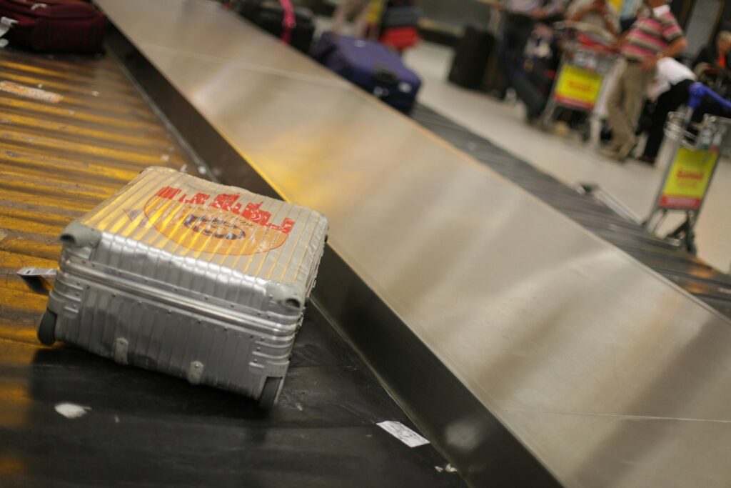 Gray hardside suitcase ready for a move abroad
