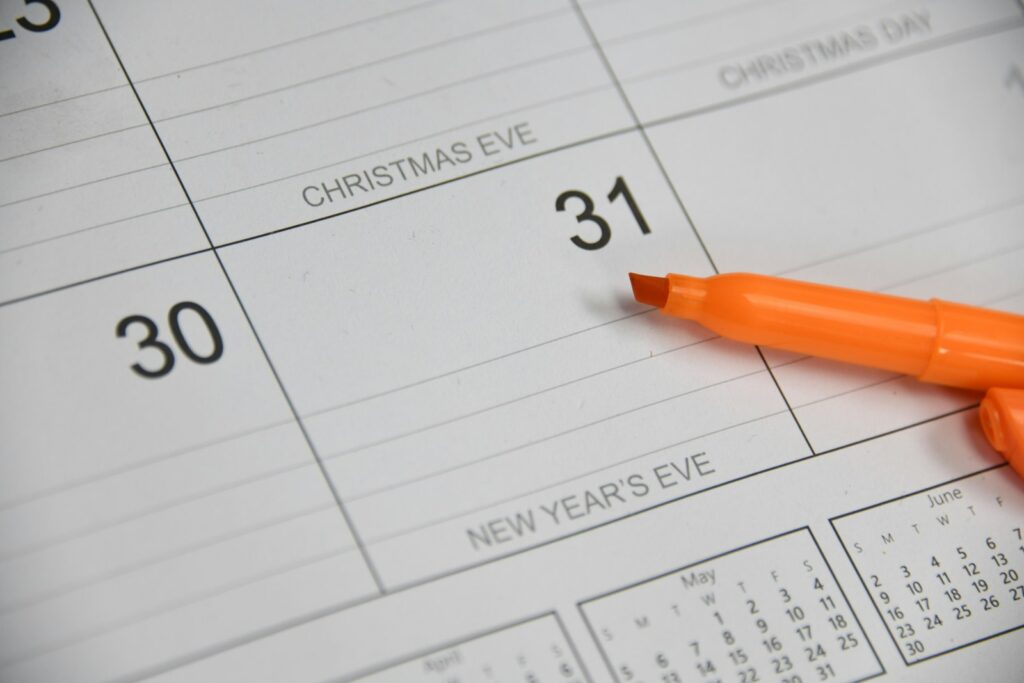 Marker resting on a paper calendar, representing year-end tax planning