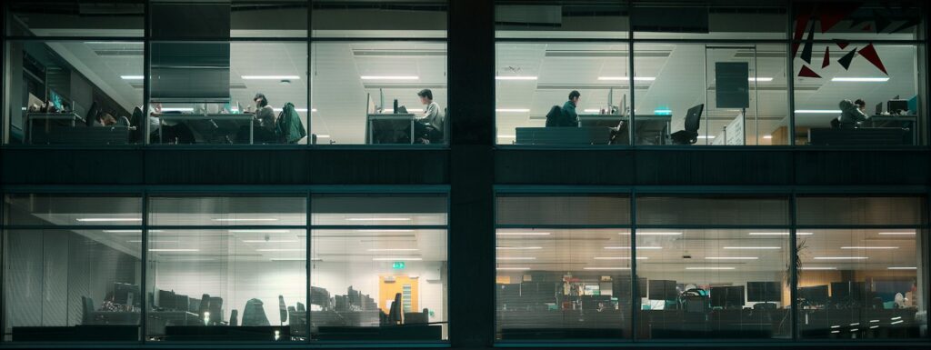 Office building windows at night with people working late